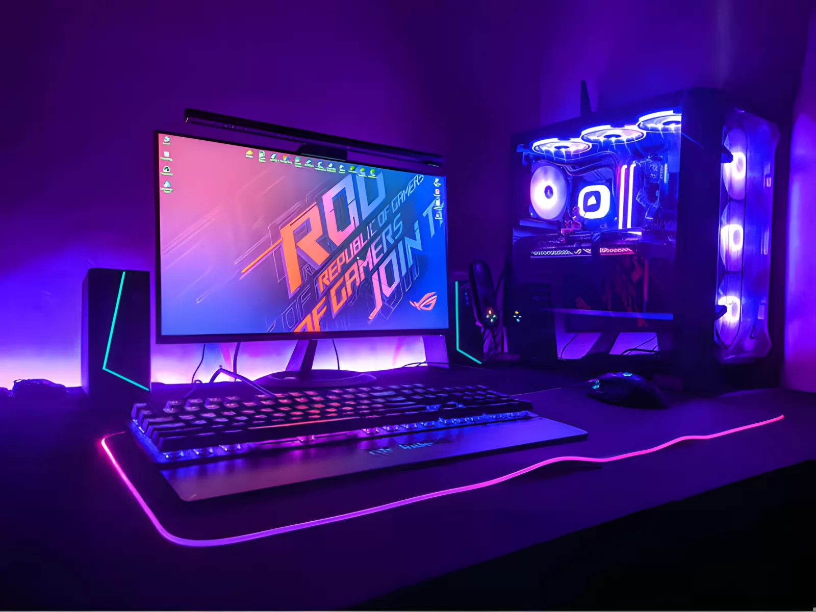 A budget gaming PC with RGB fans on a desk next to a monitor